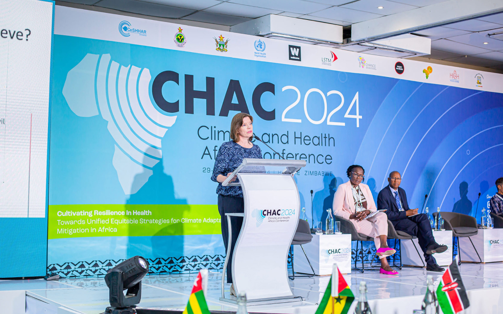 A women on stage behind a podium giving a speech at CHAC 2024