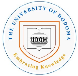 University of Dodoma (UDOM) logo featuring a shield with 'UDOM' inside and the motto 'Embracing Knowledge' around the outer circle.