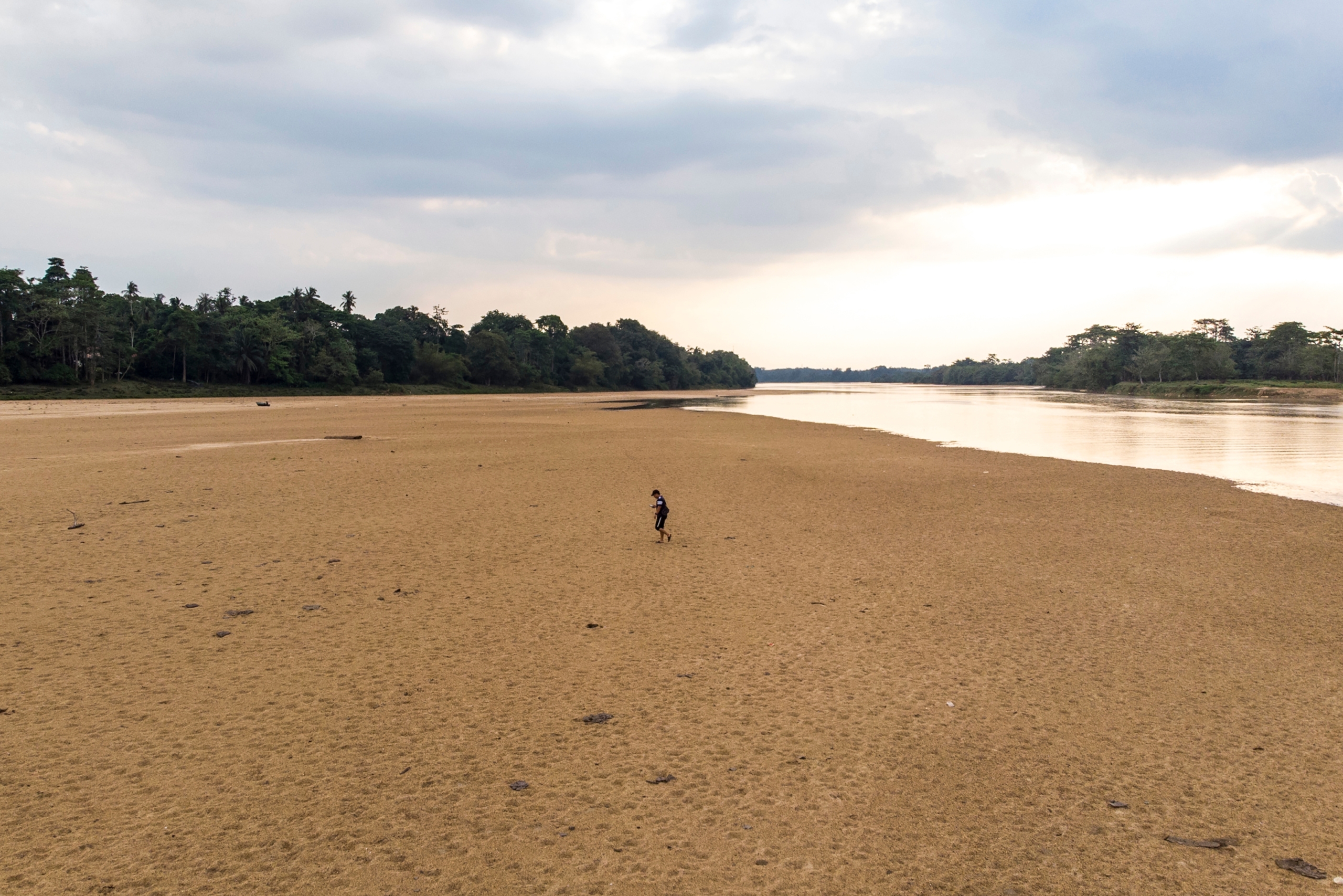 Person walking on a dry riverbed