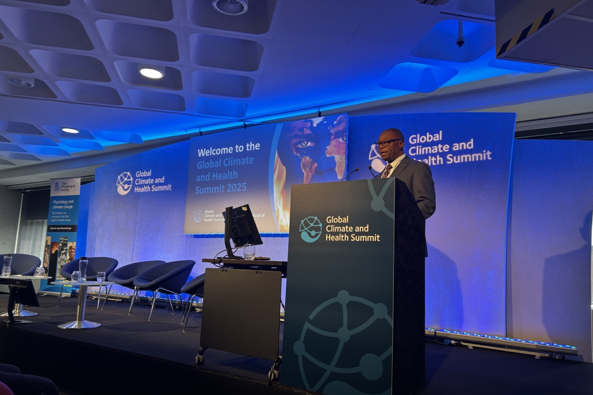 Dr Douglas Mombeshora, Zimbabwe’s Minister of Health and Child Care stands at a podium on the stage at the Global Climate and Health Summit in London